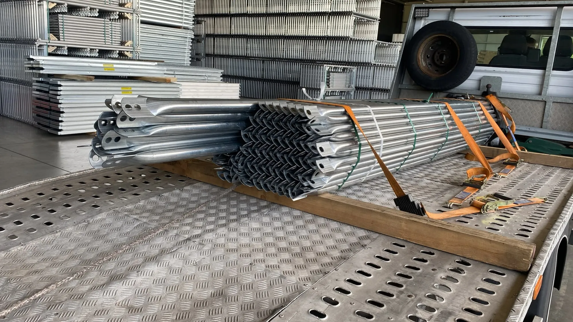 Botte de tubes et de lisses d'échafaudage en acier galvanisé sanglée sur un plateau